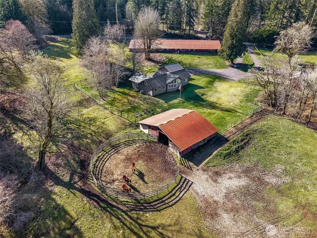 an aerial view of a house with a yard basket ball court