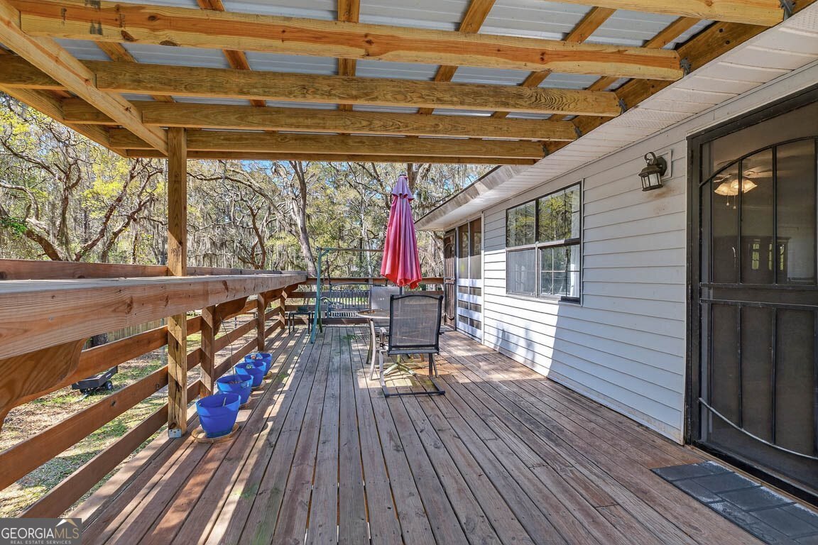 33 Warren Avenue Waverly, GA 31565 - Photo 20 of 63 a view of a deck with wooden floor and outdoor seating