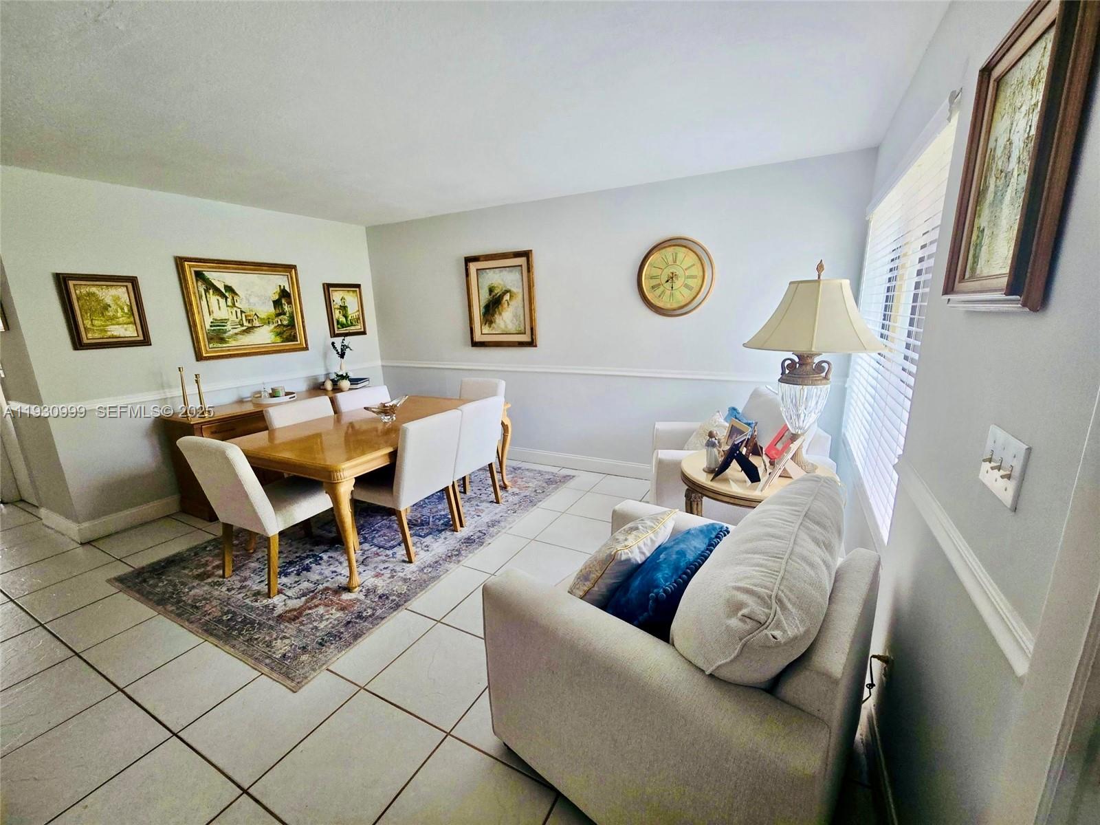 11527 Southwest 90th Terrace Miami, FL 33176 - Photo 4 of 20 a living room with a couch and a table