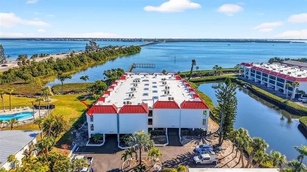 a view of a balcony with chairs and potted plants