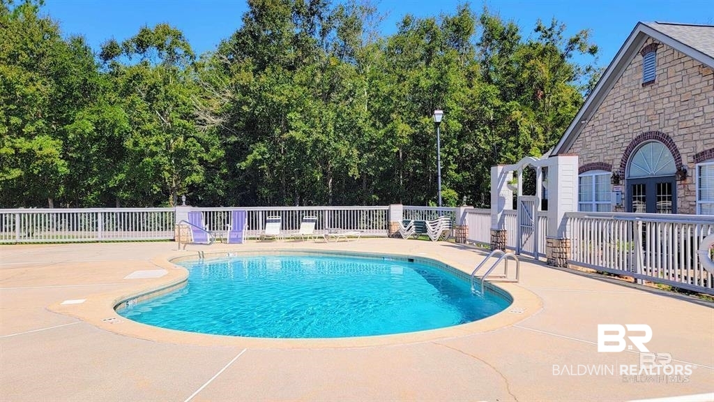 303 Wyld Palms Drive, Unit 303 Foley, AL 36535 - Photo 28 of 36 Community pool featuring a patio