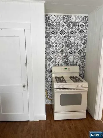 a stove top oven sitting inside of a kitchen