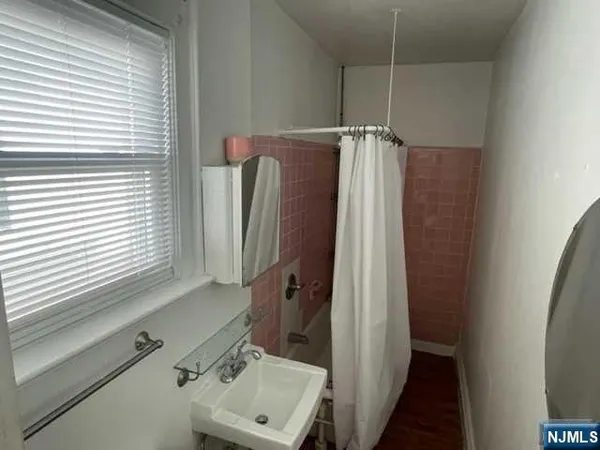 a bathroom with a shower and a sink