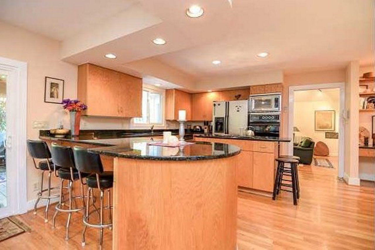 6909 Slade Hill Road Raleigh, NC 27615 - Photo 5 of 25 Another shot of kitchen with desk area in view. Kitchen has abundant custom made cabinetry, granite countertops, a huge walk-in pantry & nice gathering area/breakfast area with TV hook ups on wall & in built-in cabinet. New windows & new 8' sliding door. Kitchen
