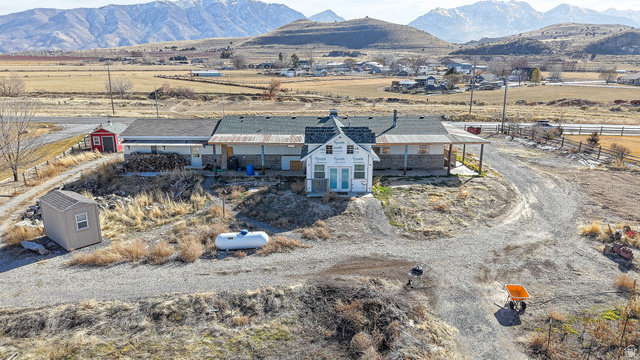 718 South State Street Genola, UT 84655 - Photo 7 of 19 Expansive property featuring a central white structure with a prominent cupola