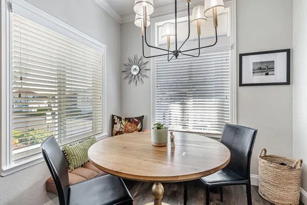 a view of a dining room with furniture and chandelier