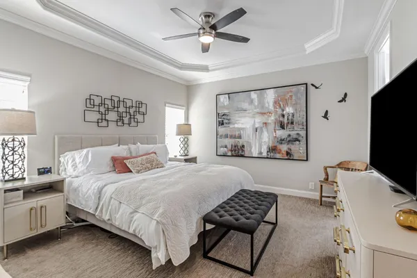 a bedroom with a bed couches and a window