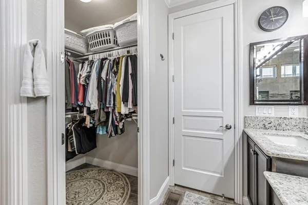 a bathroom with a granite countertop sink a toilet and shower