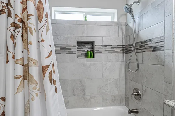 a bathroom with a shower sink and toilet