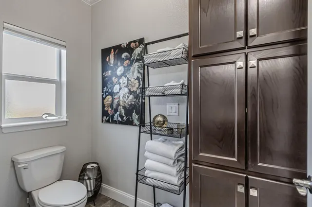 a view of a patio with couches and table and chairs under an umbrella