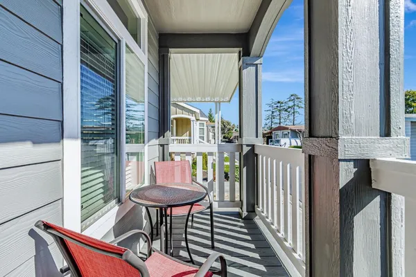 a view of a chair and table in the balcony