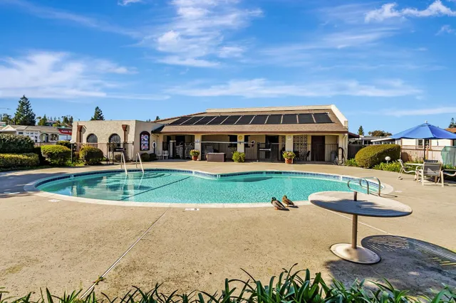 an aerial view of a city with lots of residential buildings and mountain view in back