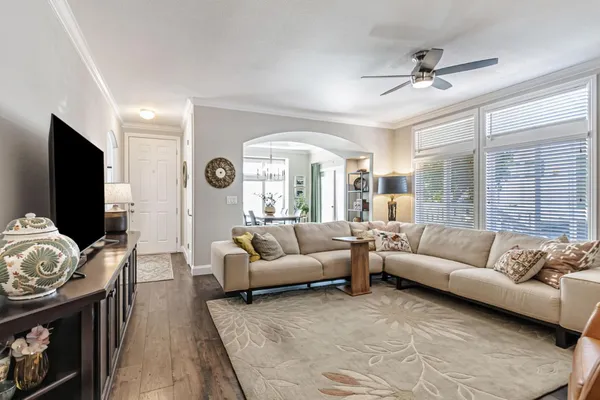 a living room with furniture a large window and a fireplace