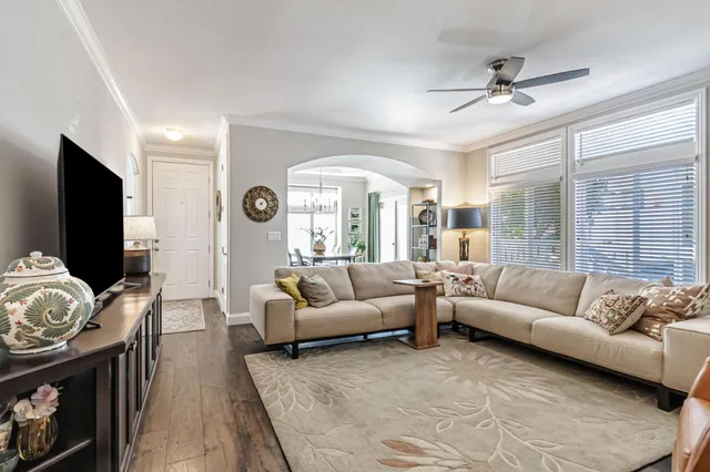 a living room with furniture a large window and a fireplace