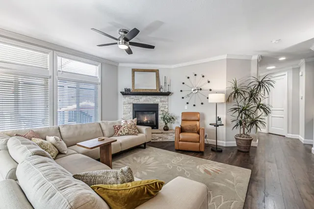 a living room with furniture a flat screen tv and a fireplace