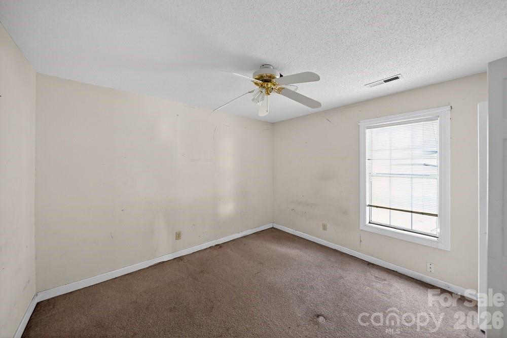 2205 Old Sparta Road Rocky Mount, NC 27804 - Photo 15 of 25 an empty room with a window and a fan