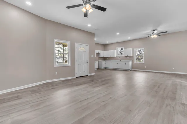 a view of cabinets a sink and a microwave in a room