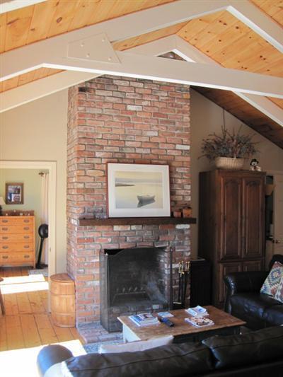 150 Pine Point Road Wellfleet, MA 02667 - Photo 3 of 11 a living room with furniture and a fireplace