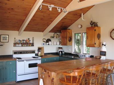 150 Pine Point Road Wellfleet, MA 02667 - Photo 4 of 11 a kitchen with a stove and a white refrigerator