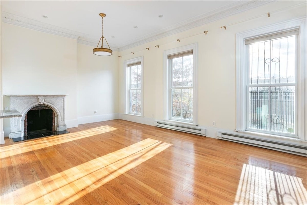 a view of a livingroom with a fireplace and window