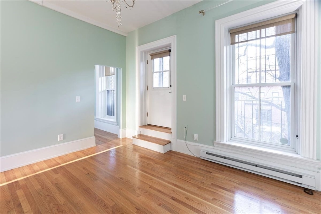 65 Worcester Street, Unit 3 Boston, MA 02118 - Photo 6 of 9 a view of an empty room with wooden floor and a window