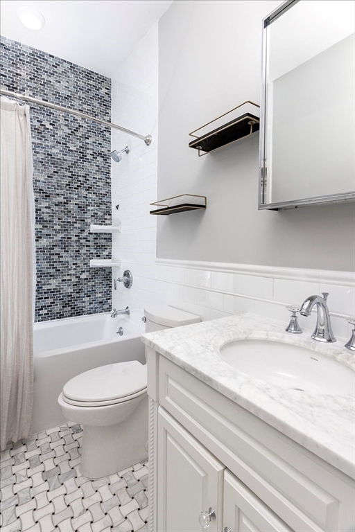 65 Worcester Street, Unit 3 Boston, MA 02118 - Photo 7 of 9 a bathroom with a granite countertop sink a toilet and a bathtub