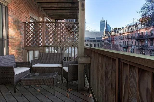 a balcony with a bench and painted walls
