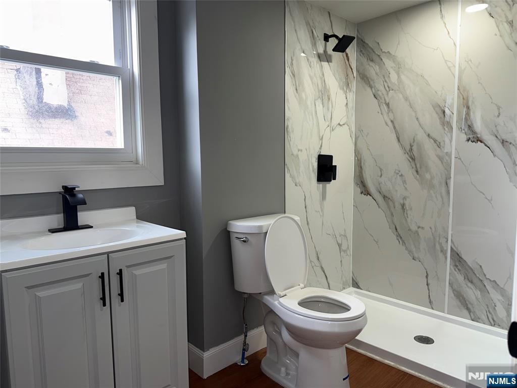 178 Berry Street Hackensack, NJ 07601 - Photo 20 of 22 a bathroom with a sink a toilet and a shower