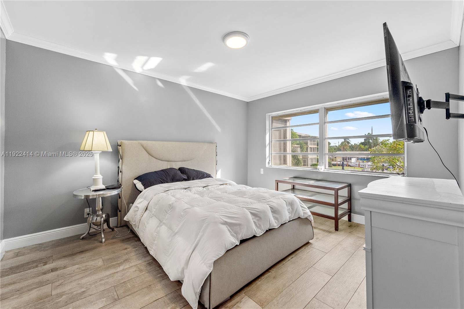 900 Southwest 12th Street, Unit 206 Fort Lauderdale, FL 33315 - Photo 11 of 24 a bedroom with a bed and a large window