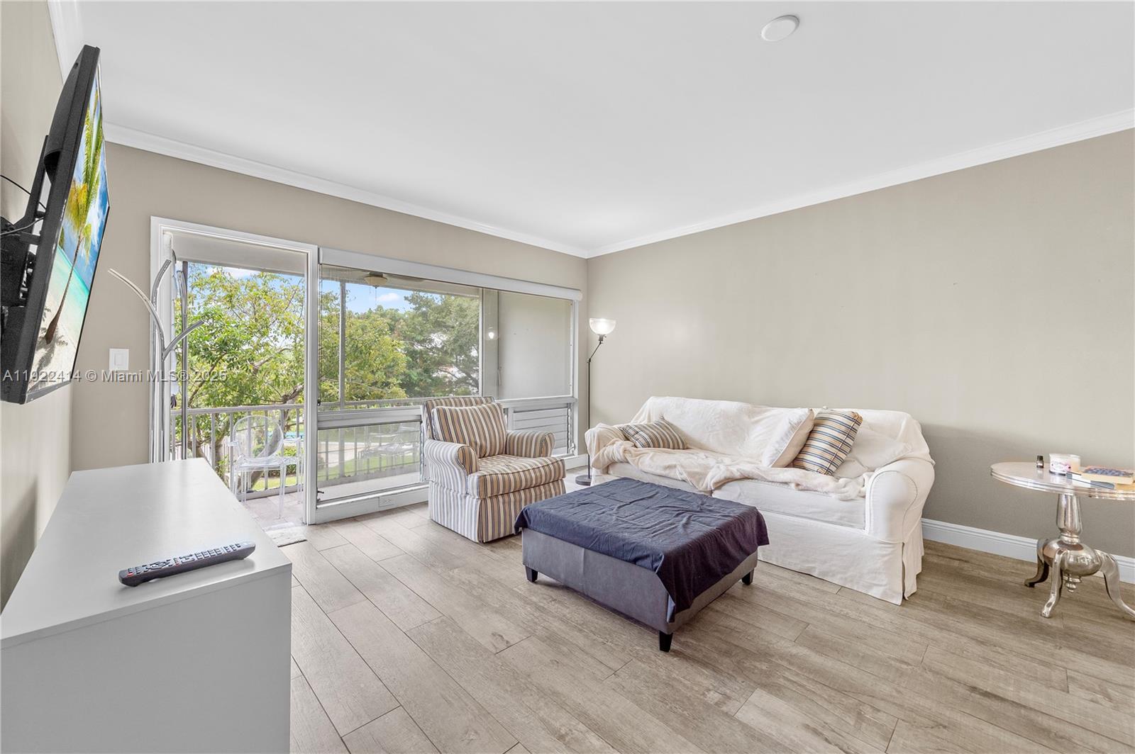 900 Southwest 12th Street, Unit 206 Fort Lauderdale, FL 33315 - Photo 13 of 24 a living room with furniture and a large window