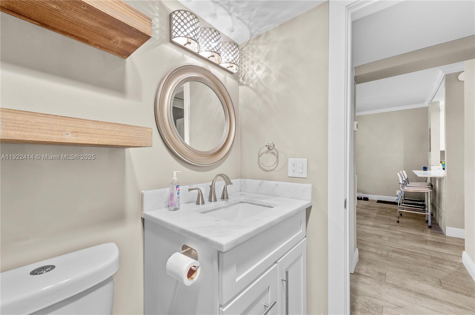 900 Southwest 12th Street, Unit 206 Fort Lauderdale, FL 33315 - Photo 16 of 24 a spacious bathroom with a sink a mirror and a toilet