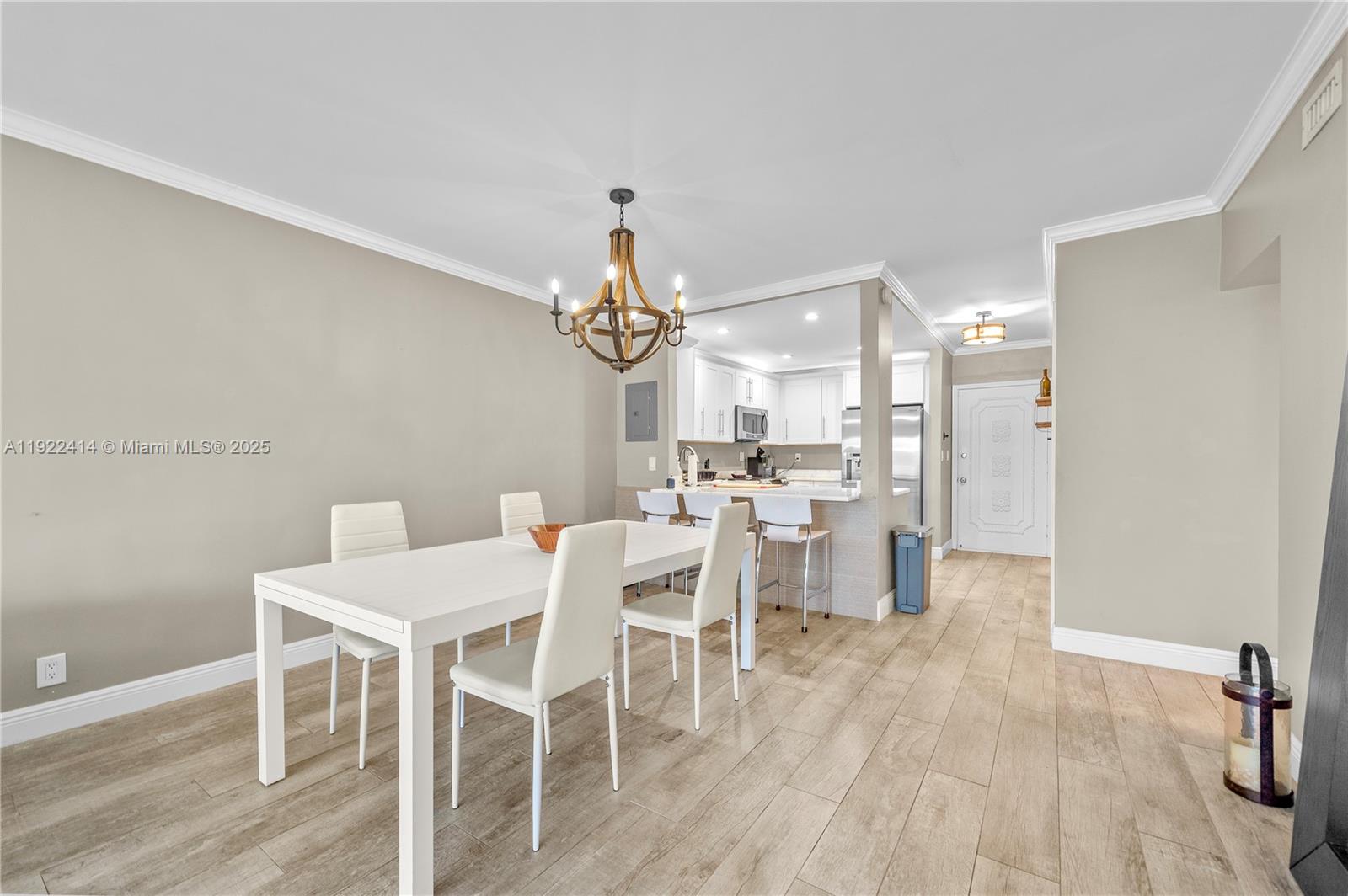 900 Southwest 12th Street, Unit 206 Fort Lauderdale, FL 33315 - Photo 5 of 24 a dining room with furniture a chandelier and wooden floor