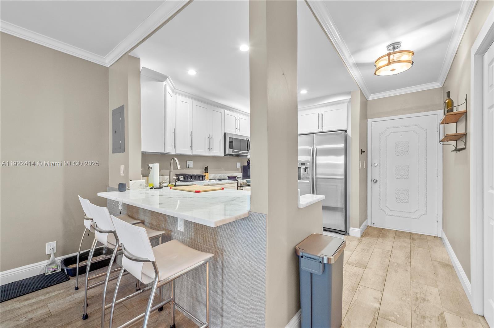 900 Southwest 12th Street, Unit 206 Fort Lauderdale, FL 33315 - Photo 6 of 24 a kitchen with a sink a refrigerator and cabinets