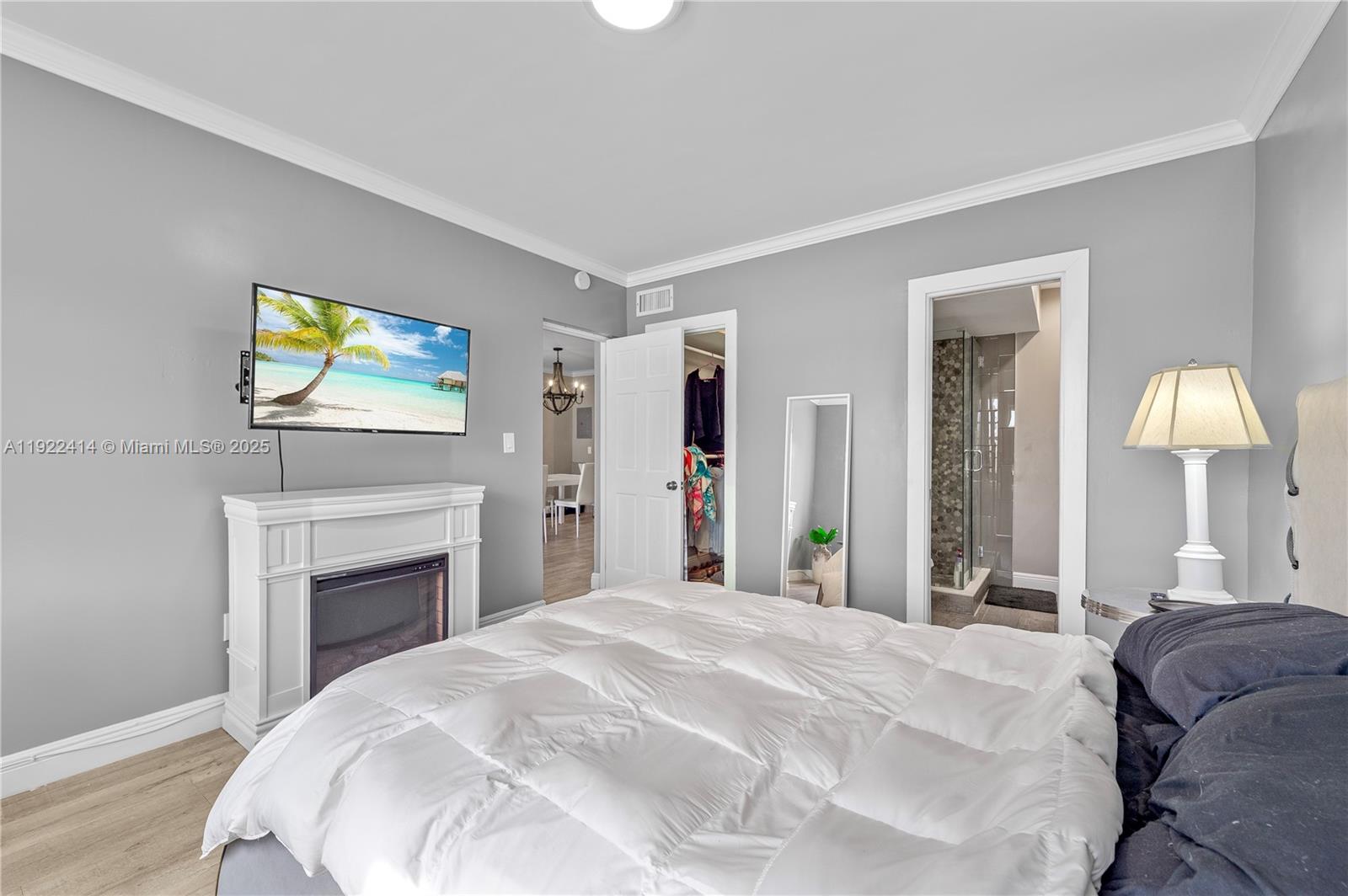 900 Southwest 12th Street, Unit 206 Fort Lauderdale, FL 33315 - Photo 9 of 24 a bedroom with a bed and a chandelier