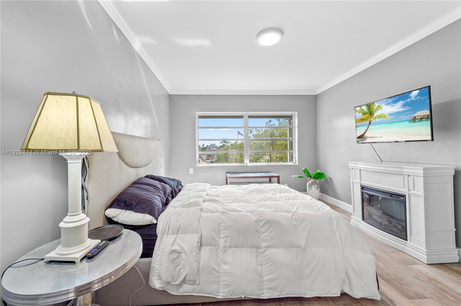 900 Southwest 12th Street, Unit 206 Fort Lauderdale, FL 33315 - Photo 10 of 24 a bed room with a bed and a fireplace