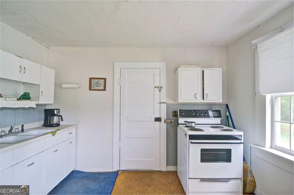 2165 Townsend Mill Road Young Harris, GA 30582 - Photo 5 of 12 a kitchen with cabinets appliances and a wooden floor