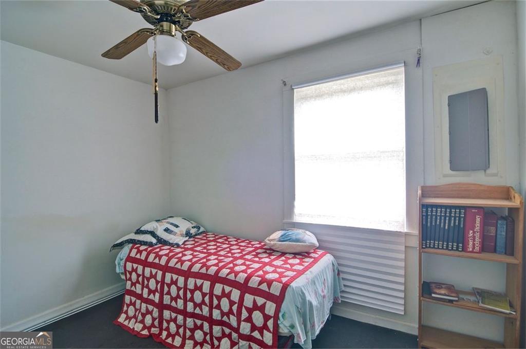 2165 Townsend Mill Road Young Harris, GA 30582 - Photo 6 of 12 a bedroom with a bed and a chandelier