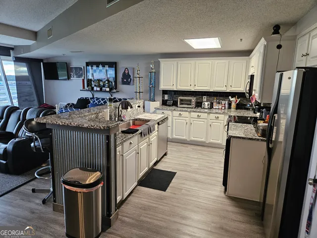 a kitchen with a sink appliances and cabinets