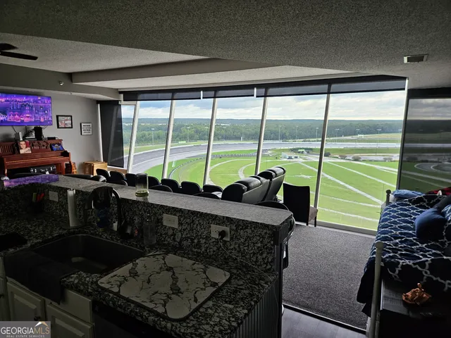 a living room with a large window and a table
