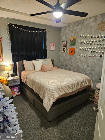 a bedroom with a bed window and a table