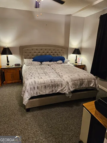 a bedroom with bed and window