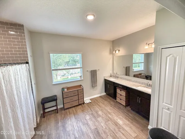 a kitchen with sink cabinets and wooden floor
