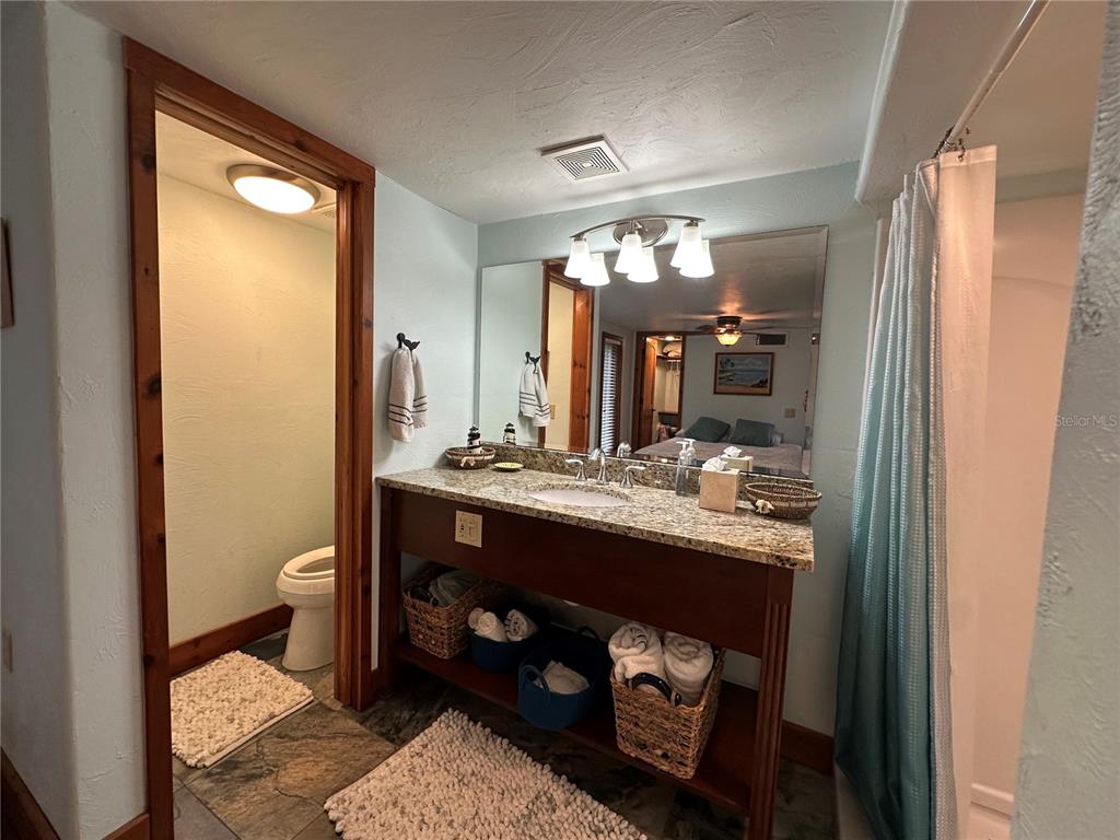 56315 Hickory Road Astor, FL 32102 - Photo 14 of 31 a bathroom with a double vanity sink and a mirror