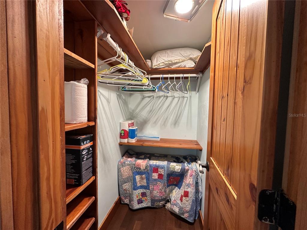 56315 Hickory Road Astor, FL 32102 - Photo 15 of 31 a view of walk in closet with clothes and shoes