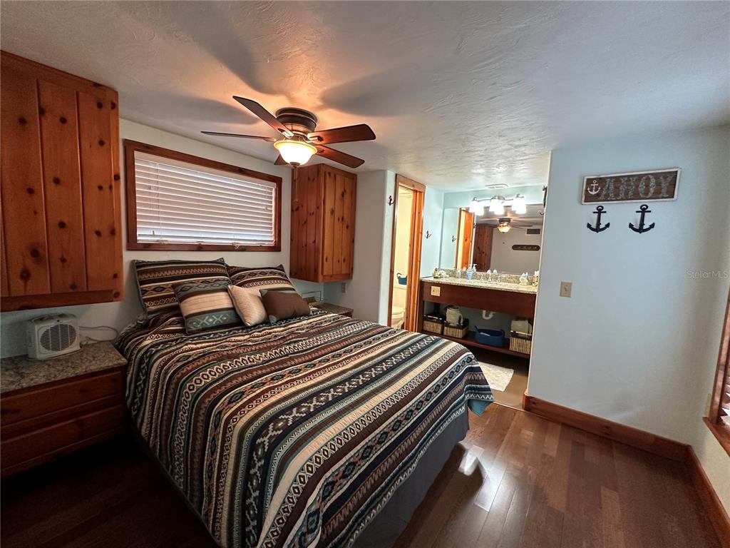 56315 Hickory Road Astor, FL 32102 - Photo 18 of 31 a bedroom with a bed and wooden floor