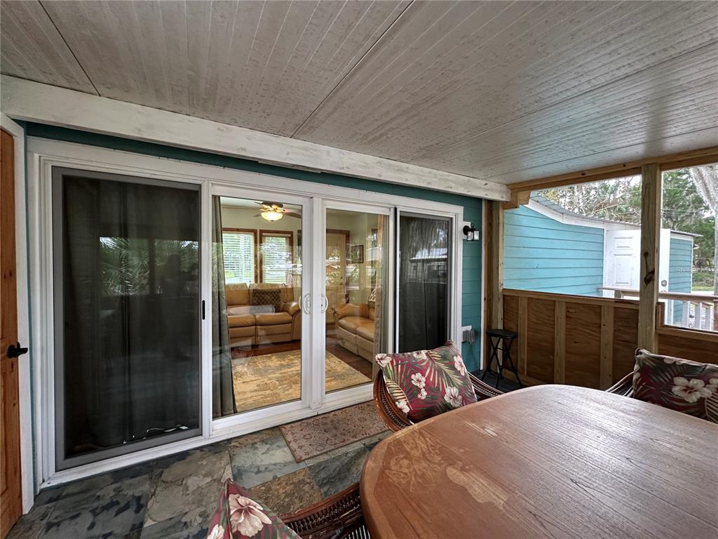 56315 Hickory Road Astor, FL 32102 - Photo 24 of 31 a bedroom with a bed large mirror and a large window