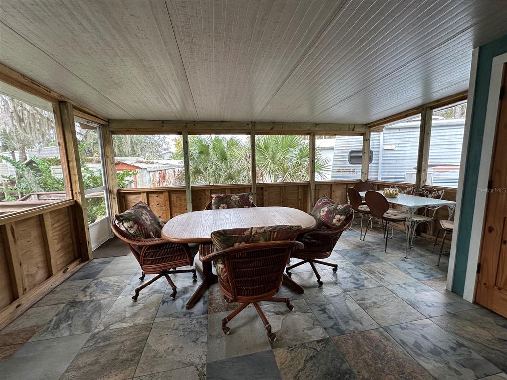 56315 Hickory Road Astor, FL 32102 - Photo 25 of 31 a view of a dining room with furniture window and outside view