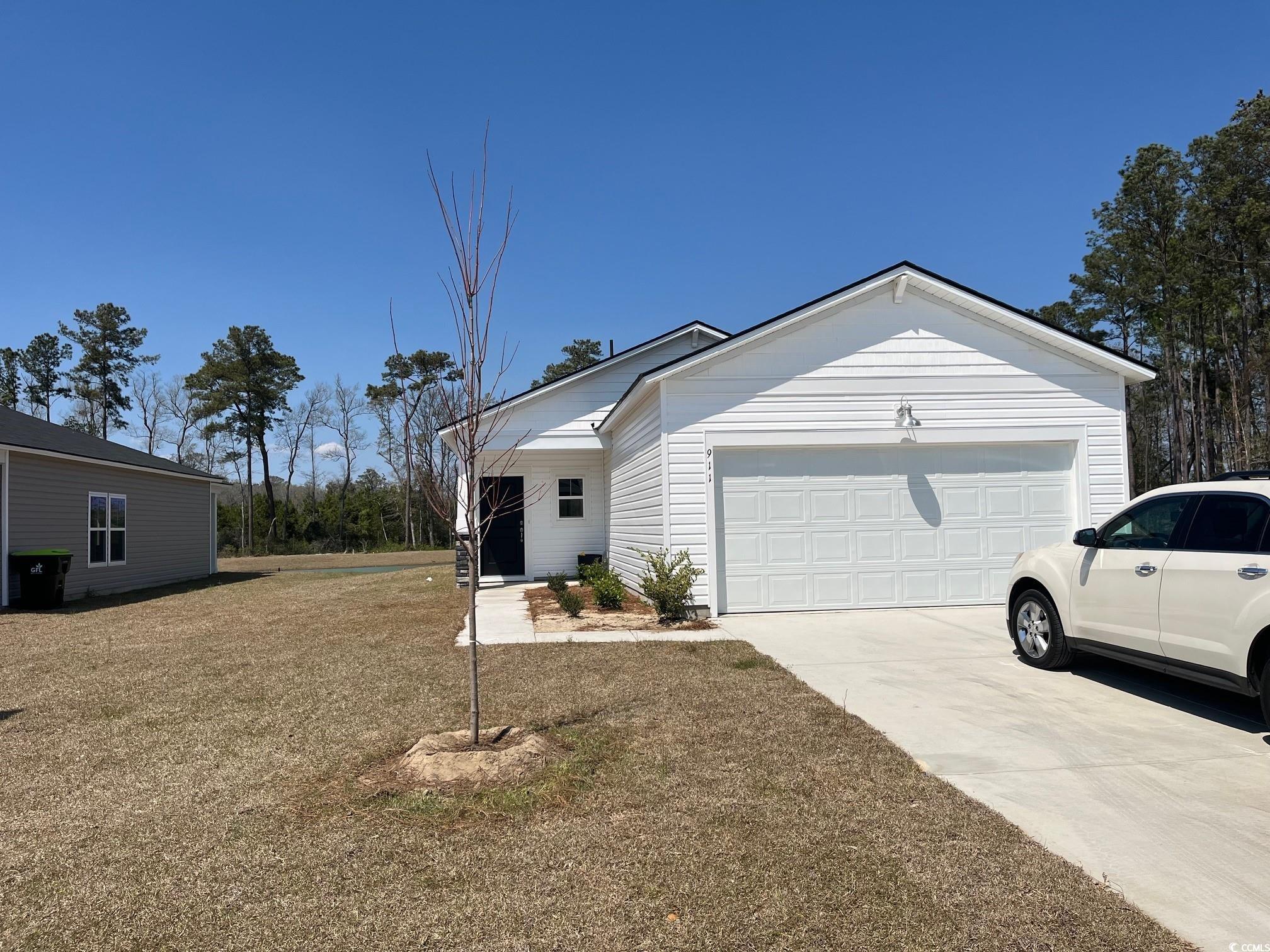 911 Long Bch Loop Longs, SC 29568 - Photo 1 of 15 View of front facade featuring driveway and a gara