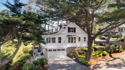 a front view of a house with a yard and outdoor seating