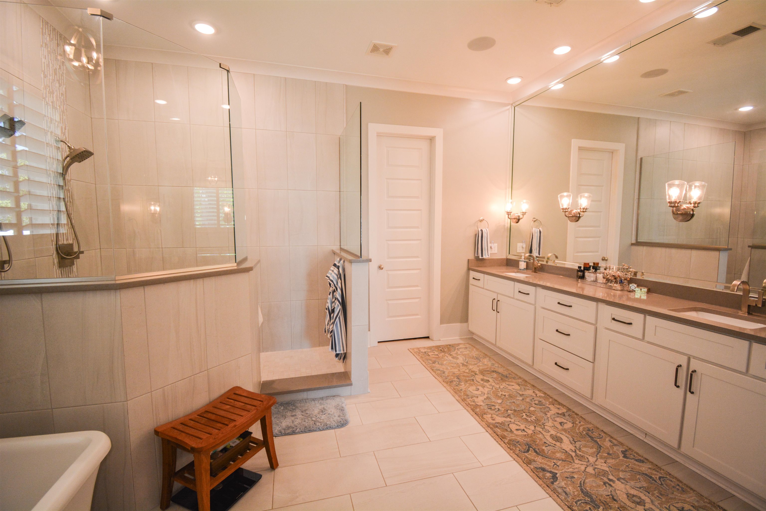 5293 Cole Road Memphis, TN 38120 - Photo 11 of 40 a spacious bathroom with a double vanity sink a mirror and a bathtub